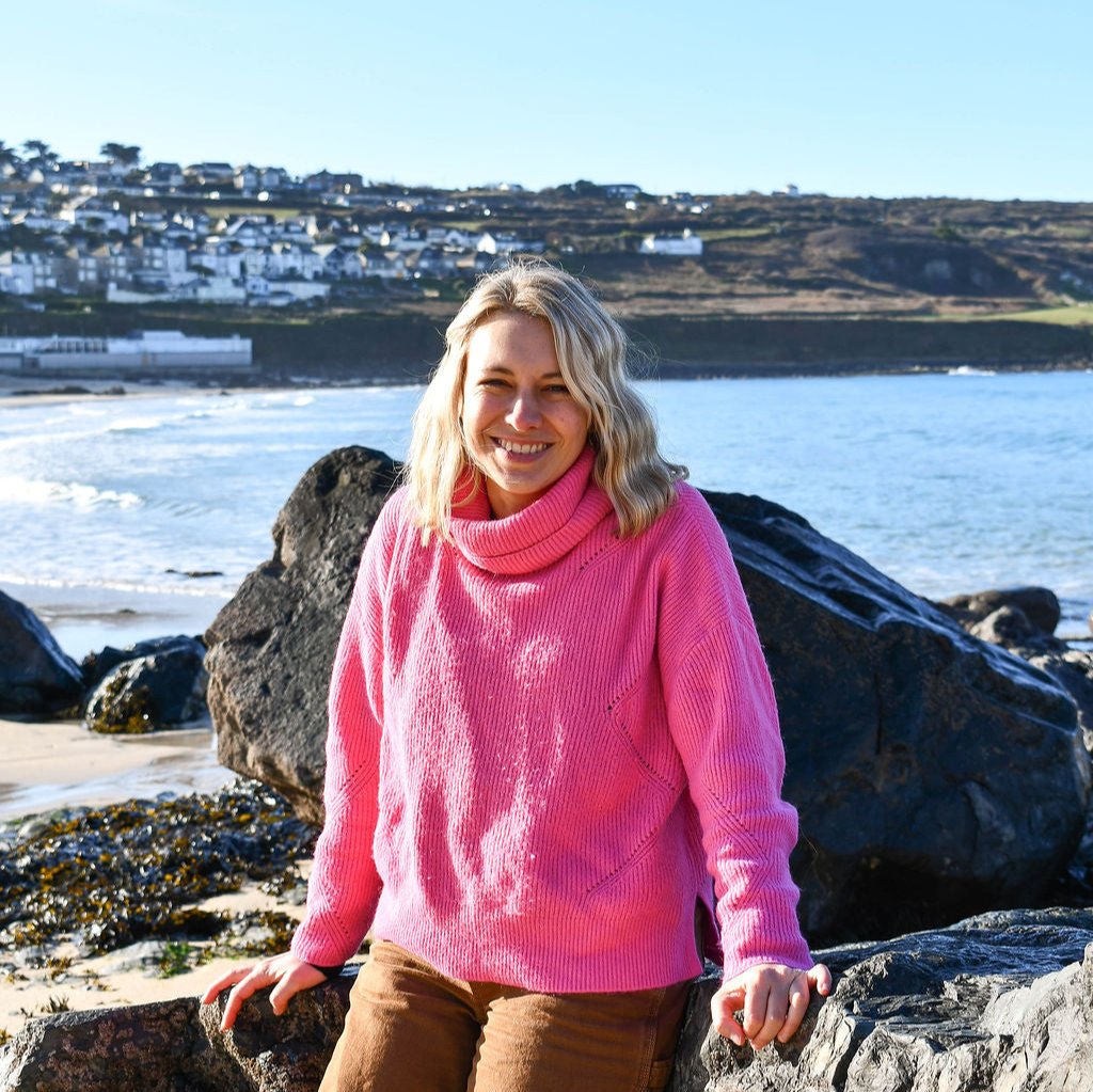 Jo sat on some rocks on Porthmeor beach, smiling